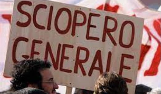 Due teste di persone che sorreggono un cartello con la scritta "sciopero generale"