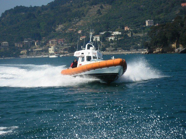 Motovedetta guardia costiera soccorre marittimo a bordo di una nave