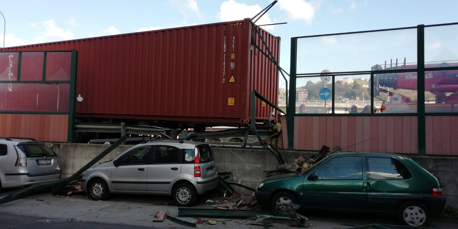 Camion finisce sul guardrail, abbatte la protezione e danneggia le auto parcheggiate